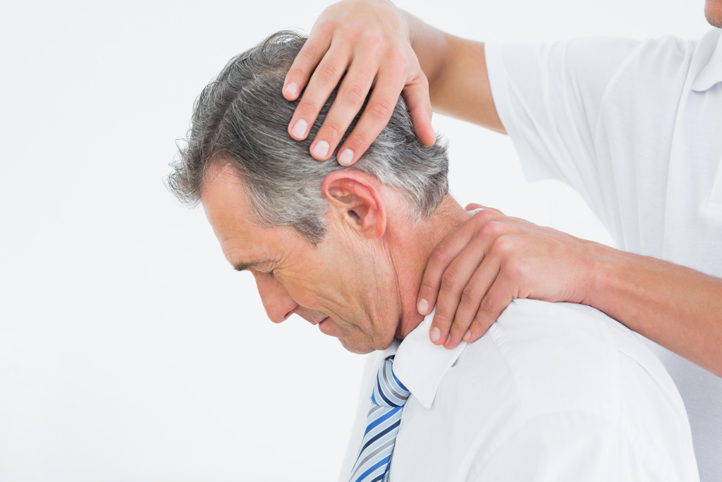 Side-view-of-chiropractor-doing-neck-adjustment